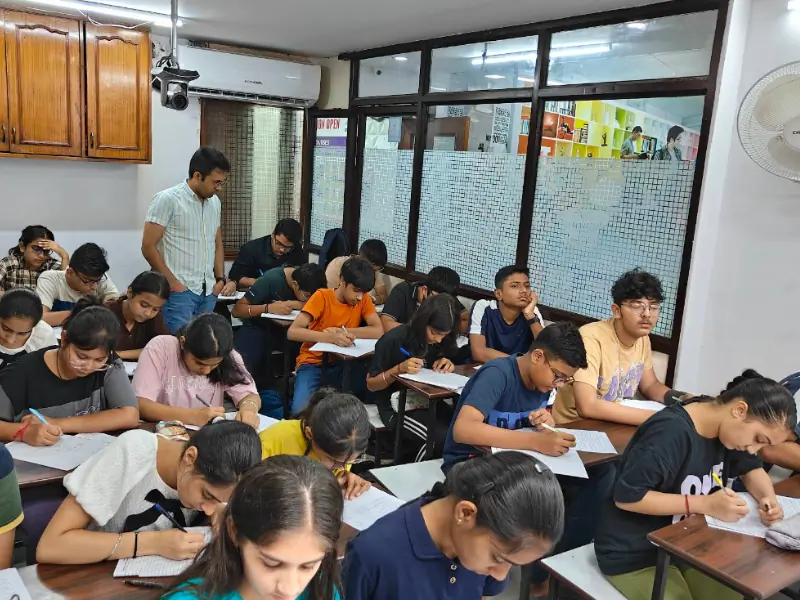 Students studying diligently in a quiet study hall at Toppers Academy